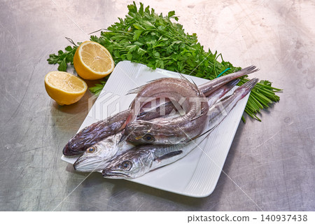 Pescadilla on a white plate with parsley and lemon 140937438
