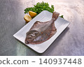 Flounder or plaice fish on a white plate with parsley and lemon 140937448