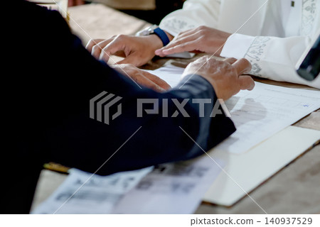 Islamic Marriage Contract Ceremony (Akad Nikah) - Religious Officiant Joining Hands with Groom During Ijab Qabul Ritual Islamic Marriage Contract Ceremony (Akad Nikah) - Religious Officiant Joining Hands with Groom During Ijab Qabul Ritual 140937529