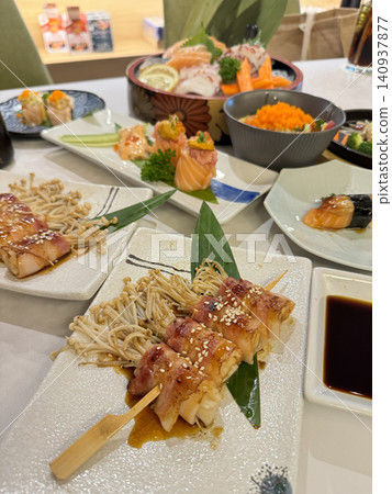 Assorted Japanese Feast With Bacon Skewers Sashimi And Sushi Assorted Japanese Feast With Bacon Skewers Sashimi And Sushi 140937877