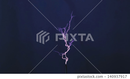 Electrical discharge creating a branching lightning bolt on a dark blue background Electrical discharge creating a branching lightning bolt on a dark blue background 140937917