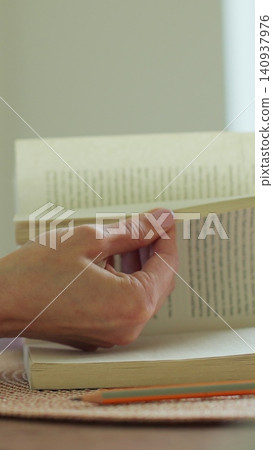 Vertical video Close-up unrecognizable woman reading a book. Vertical video Close-up unrecognizable woman reading a book. 140937976