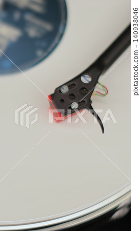Vertical video Close-up of a vinyl record spinning on a retro turntable from top view. Classic vinyl record player. Vertical video Close-up of a vinyl record spinning on a retro turntable from top view. Classic vinyl record player. 140938046