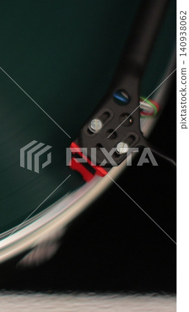 Vertical video Close-up of a vinyl record spinning on a retro turntable from top view. Classic vinyl record player. Vertical video Close-up of a vinyl record spinning on a retro turntable from top view. Classic vinyl record player. 140938062
