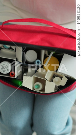 Vertical video Woman open the first aid kit at home. First aid kit. Vertical video Woman open the first aid kit at home. First aid kit. 140938120