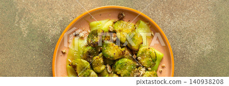 Brussels sprouts and zucchini slices are on a plate and topped with chopped walnuts. This dish can be served for breakfast or lunch. It is a healthy choice for any meal, banner Brussels sprouts and zucchini slices are on a plate and topped with chopped walnuts. This dish can be served for breakfast or lunch. It is a healthy choice for any meal, banner 140938208