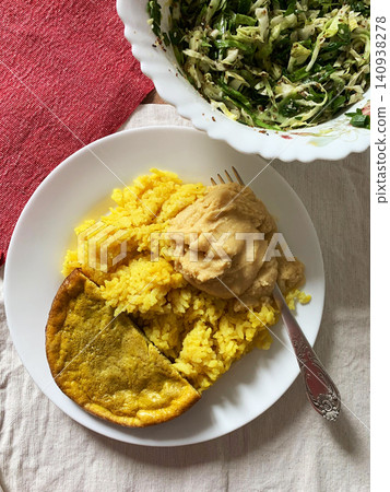 Delicious turmeric rice served with a fluffy omelette, fresh salad, and hummus makes a perfect dish for breakfast or lunch any day of the week Delicious turmeric rice served with a fluffy omelette, fresh salad, and hummus makes a perfect dish for breakfast or lunch any day of the week 140938278