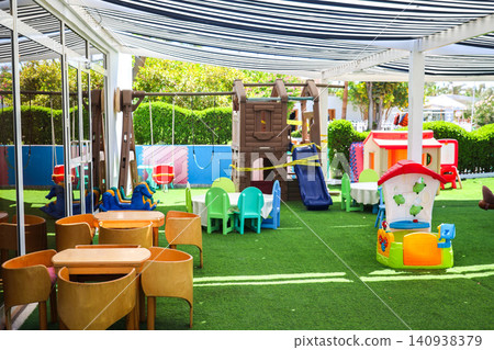 Children's playground, a fun and safe outdoor space for play and exploration under a sun canopy Children's playground, a fun and safe outdoor space for play and exploration under a sun canopy 140938379