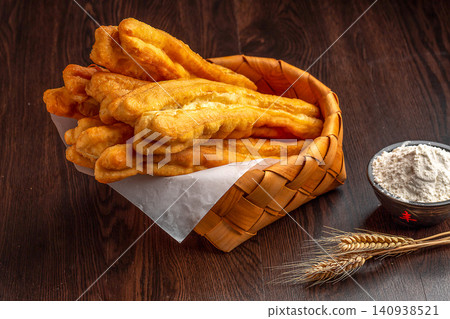 crispy Deep Fried Youtiao, Traditional Chinese Cruller and Breakfast Fried Dough Stick crispy Deep Fried Youtiao, Traditional Chinese Cruller and Breakfast Fried Dough Stick 140938521