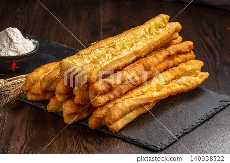 crispy Deep Fried Youtiao, Traditional Chinese Cruller and Breakfast Fried Dough Stick crispy Deep Fried Youtiao, Traditional Chinese Cruller and Breakfast Fried Dough Stick 140938522