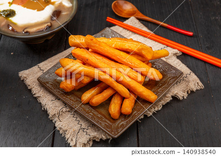 mini Fried Dough Sticks Made of Leavened Dough, Soft and Crispy Chinese Youtiao mini Fried Dough Sticks Made of Leavened Dough, Soft and Crispy Chinese Youtiao 140938540