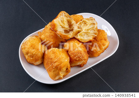 traditional Chinese Breakfast Fried Dough Bites, Golden Puffy Oil Motou Pastry traditional Chinese Breakfast Fried Dough Bites, Golden Puffy Oil Motou Pastry 140938541