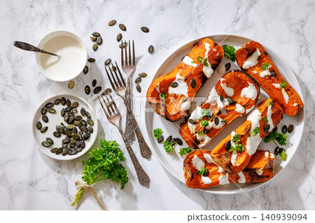 Baked butternut squash halves with yogurt sauce Baked butternut squash halves with yogurt sauce 140939094