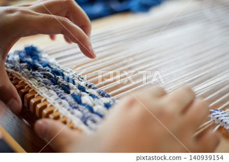 Weaving on a loom frame 140939154