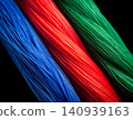 Ultra-thin strands composed of vibrant fibres, isolated against a deep black 140939163