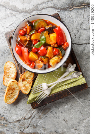 Ciambotta or giambotta is a summer vegetable stew of southern Italian cuisine closeup on the plate. Vertical top view Ciambotta or giambotta is a summer vegetable stew of southern Italian cuisine closeup on the plate. Vertical top view 140939206