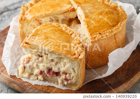 Pizzagaina, also known as Easter pie, pizza rustica, pizza chiena, or pizza gain, is a savory meat pie that is traditionally eaten on Easter morning closeup. Horizontal Pizzagaina, also known as Easter pie, pizza rustica, pizza chiena, or pizza gain, is a savory meat pie that is traditionally eaten on Easter morning closeup. Horizontal 140939220