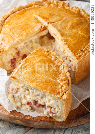 Pizza Gaina or Pizza Rustica is an Italian easter pie with mortadella, salami, mozzarella, and pecorino romano closeup. Vertical Pizza Gaina or Pizza Rustica is an Italian easter pie with mortadella, salami, mozzarella, and pecorino romano closeup. Vertical 140939222