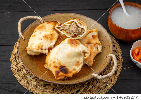 traditional Xinjiang Roasted Mutton Buns, Crispy Clay Oven Baked Samsa with Meat Filling 140939277