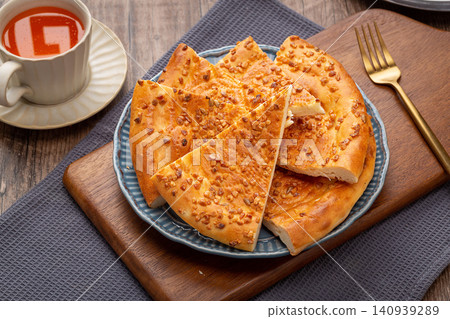 xinjiang Naan Flatbread Topped with Roasted Peanuts, Traditional Nutty Flavor Flatbread 140939289