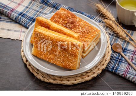 traditional Xinjiang Layered Naan Flatbread, Golden Crispy Roasted Bread with Sesame traditional Xinjiang Layered Naan Flatbread, Golden Crispy Roasted Bread with Sesame 140939293