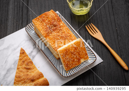 traditional Xinjiang Layered Naan Flatbread, Golden Crispy Roasted Bread with Sesame traditional Xinjiang Layered Naan Flatbread, Golden Crispy Roasted Bread with Sesame 140939295