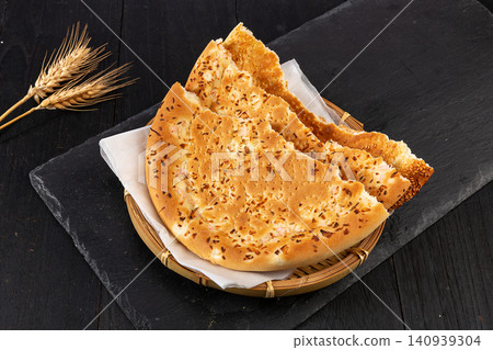 xinjiang Naan Flatbread Seasoned with Cumin, Traditional Aromatic Roasted Silk Road Bread 140939304
