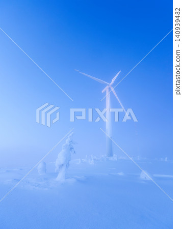 Winter landscape of a single wind turbine at sunset or twilight. Winter landscape of a single wind turbine at sunset or twilight. 140939482