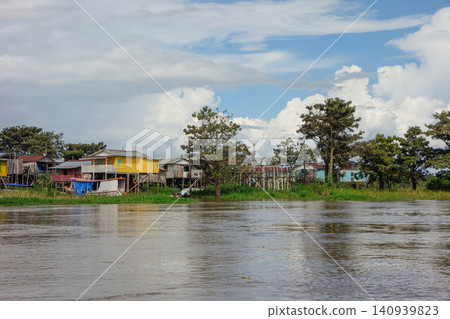 wooden stilt houses belonging to riverside dwellers along banks of tropical river. nearby Manaus, Brazil wooden stilt houses belonging to riverside dwellers along banks of tropical river. nearby Manaus, Brazil 140939823