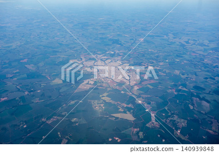 Aerial view over secluded town surrounded by agricultural plantations in the interior of Brazil Aerial view over secluded town surrounded by agricultural plantations in the interior of Brazil 140939848