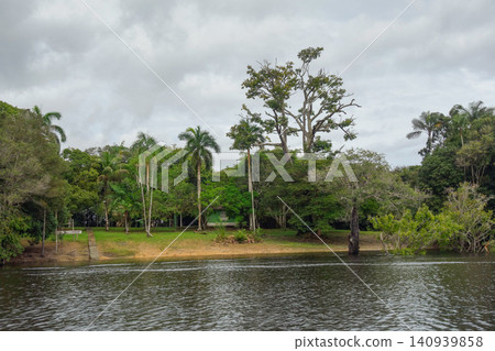 flooded riverbanks of amazon rainforest with riverside wooden houses, nearby Manaus, Brazil flooded riverbanks of amazon rainforest with riverside wooden houses, nearby Manaus, Brazil 140939858