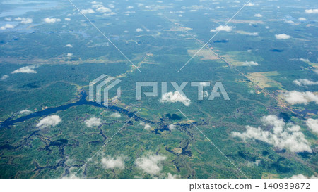 Aerial view over immense Amazon rainforest with a wide river cutting through forest. Amazonas, Brazil 140939872