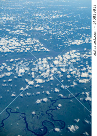 Aerial view of narrow and winding river into immense Amazon rainforest. Amazonas, Brazil Aerial view of narrow and winding river into immense Amazon rainforest. Amazonas, Brazil 140939912