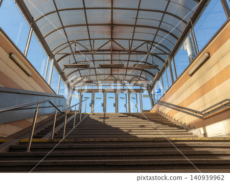 A pedestrian subway staircase with a glass canopy in an urban environment provides safe public transit infrastructure for commuters during morning travel in a modern metropolitan city A pedestrian subway staircase with a glass canopy in an urban environment provides safe public transit infrastructure for commuters during morning travel in a modern metropolitan city 140939962