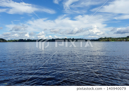 low angle shows surface of a lagoon in flooded Amazon rainforest. Amazon basin. Amazonas, Brazil low angle shows surface of a lagoon in flooded Amazon rainforest. Amazon basin. Amazonas, Brazil 140940079
