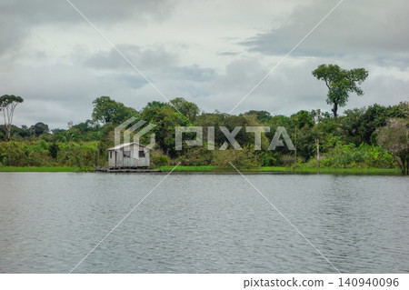 flooded riverbanks of amazon rainforest with riverside wooden houses, nearby Manaus, Brazil flooded riverbanks of amazon rainforest with riverside wooden houses, nearby Manaus, Brazil 140940096