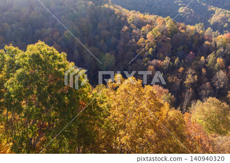 Wooded sunset hills of Appalachian mountains in North Carolina with lush and evergreen forest trees at fall season. Beauty of autumnal nature Wooded sunset hills of Appalachian mountains in North Carolina with lush and evergreen forest trees at fall season. Beauty of autumnal nature 140940320