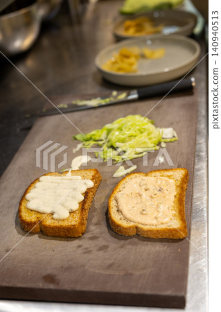 Close-up of gourmet beef sandwiches with sliced avocado and melted cheese 140940513
