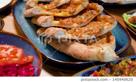 Full Turkish Family Feast Table with Traditional Food, Grilled Meat, Meze and Rustic Bread 140940620