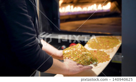 Man Preparing and baking pita kiymal pide and lahmacun. Turkish pizza video Man Preparing and baking pita kiymal pide and lahmacun. Turkish pizza video 140940625