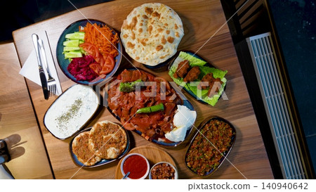Full Turkish Family Feast Table with Traditional Food, Grilled Meat, Meze and Rustic Bread 140940642