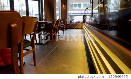 Interior of cozy modern restaurant with a bar counter and lamp lighting. Wooden restaurant interior. Video 140940655