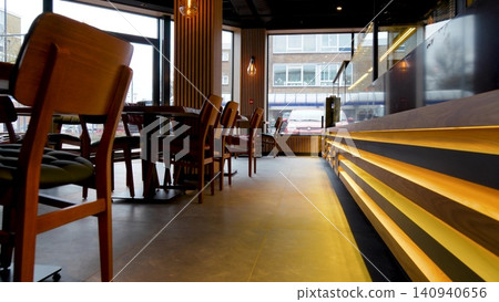 Interior of cozy modern restaurant with a bar counter and lamp lighting. Wooden restaurant interior. Video 140940656