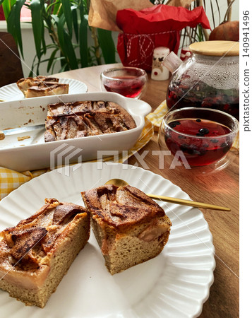 Delicious gluten free pear pie sits on a plate next to a berry drink. A bowl of pie is in the background. The scene is set for breakfast or lunch Delicious gluten free pear pie sits on a plate next to a berry drink. A bowl of pie is in the background. The scene is set for breakfast or lunch 140941496