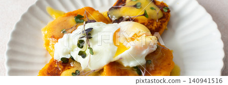 Millet pancakes are served on a plate with hollandaise sauce and a poached egg. This meal is ideal for anyone looking for a healthy breakfast or lunch option, banner Millet pancakes are served on a plate with hollandaise sauce and a poached egg. This meal is ideal for anyone looking for a healthy breakfast or lunch option, banner 140941516