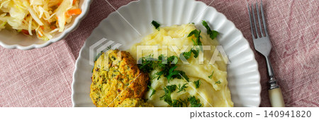 This plate features mashed potatoes, two turkey meatballs, and a side of fermented cabbage. Fresh herbs are sprinkled on top, creating a balanced meal choice, banner This plate features mashed potatoes, two turkey meatballs, and a side of fermented cabbage. Fresh herbs are sprinkled on top, creating a balanced meal choice, banner 140941820