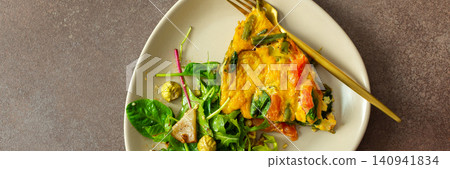 Baked vegetables with eggs sit on a plate next to a salad made from arugula and Brussels sprouts. A bowl of liver pate completes the meal with healthy choices, banner 140941834