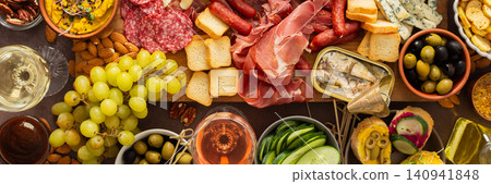 This festive spread features an array of cheese, cured meats, hummus, nuts, and fresh vegetables. Perfect for sharing at a casual get-together or celebration with friends, banner This festive spread features an array of cheese, cured meats, hummus, nuts, and fresh vegetables. Perfect for sharing at a casual get-together or celebration with friends, banner 140941848