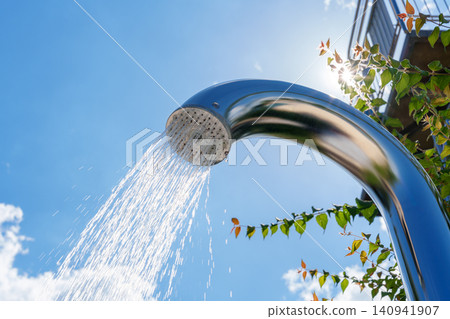 Outdoor pool shower with water stream against blue sky Outdoor pool shower with water stream against blue sky 140941907