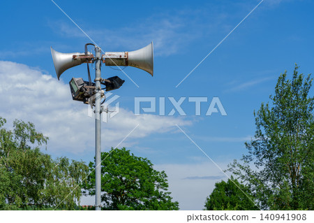 Public address loudspeakers on pole at outdoor pool Public address loudspeakers on pole at outdoor pool 140941908